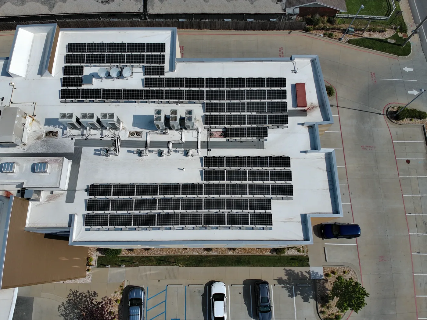 Aerial view of a large commercial rooftop solar array