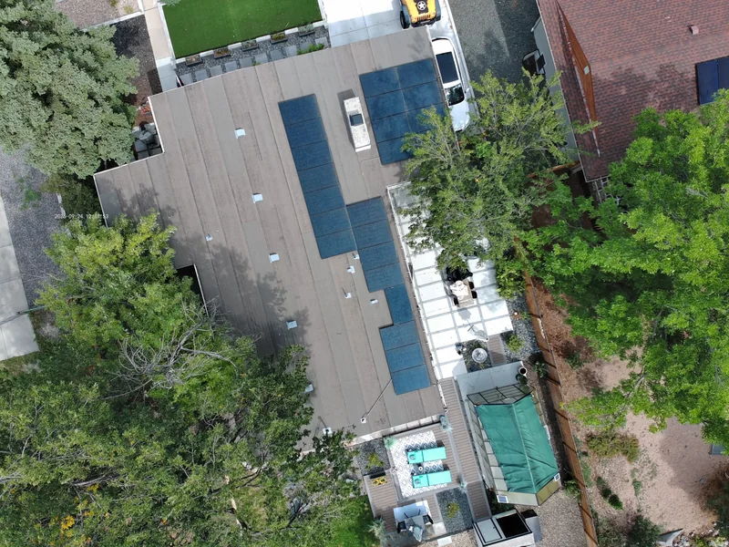 Drone view of a residential roof with multiple solar arrays